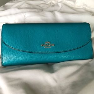 Turquoise blue crossgrain leather coach wallet.